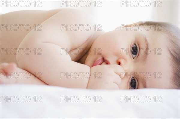 Mixed race baby boy sucking thumb