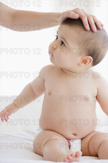 Mother comforting mixed race baby boy