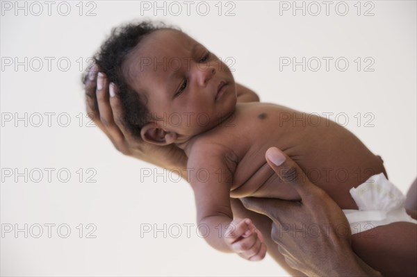 Black father holding newborn baby