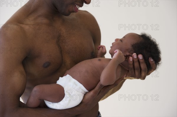 Black father holding newborn baby