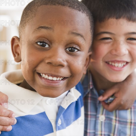 Friends smiling and hugging each other