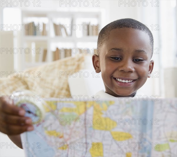 Black boy looking at map