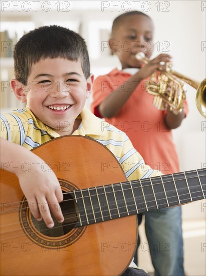 Boys playing trumpet and guitar