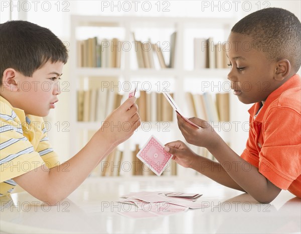 Boys playing cards together