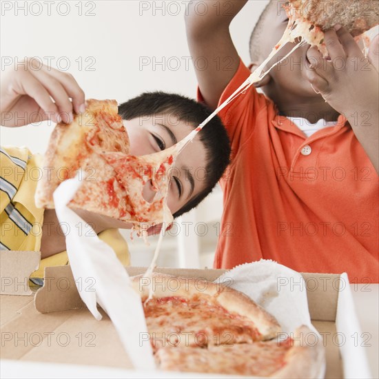 Boys eating pizza together