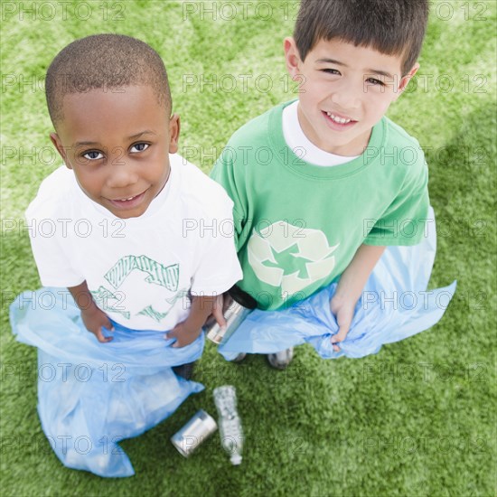 Boys with garbage bags picking up litter