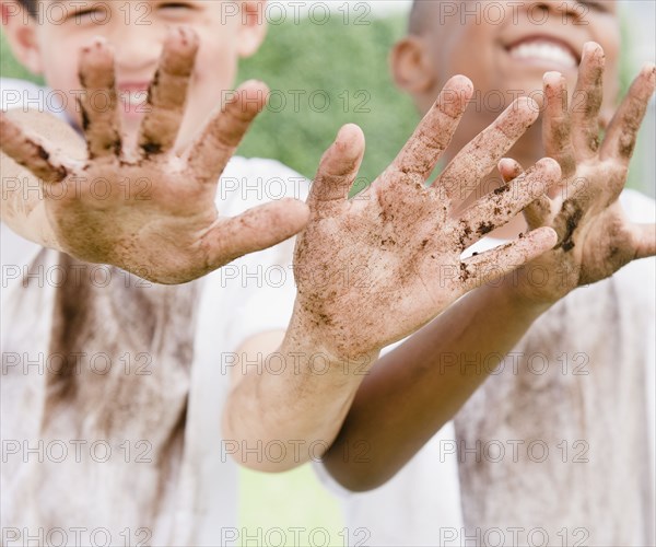 Boys displaying their messy hands