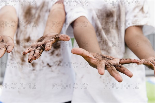 Boys displaying their messy hands
