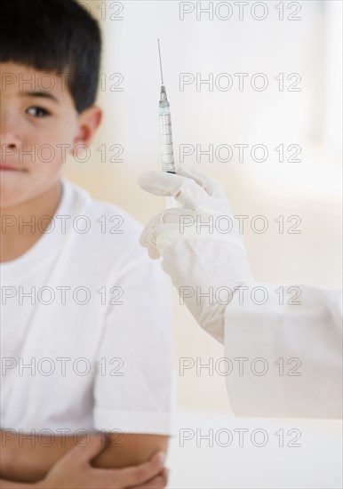 Mixed race boy worrying about injection