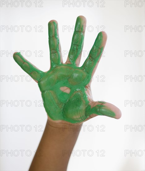 Black boy with green paint on hand