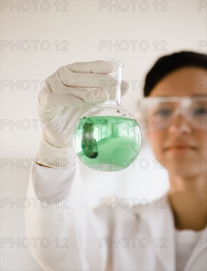 Mixed race researcher holding eco-friendly beaker