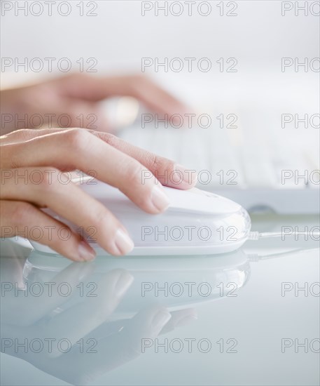 Hands operating computer mouse and keyboard