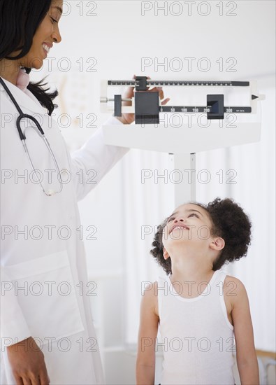 Pediatrician weighing patient