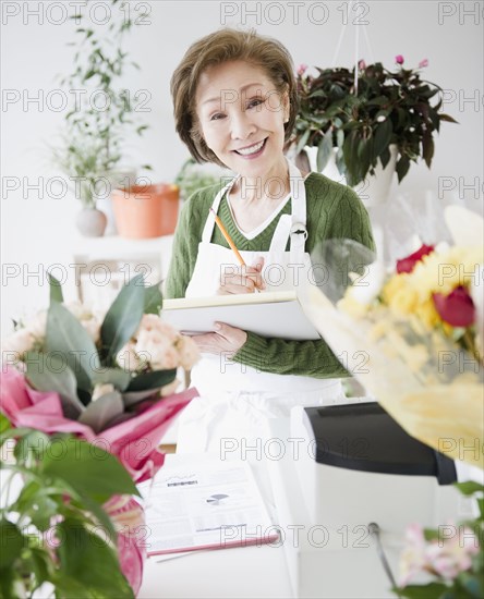 Japanese florist writing on notepad