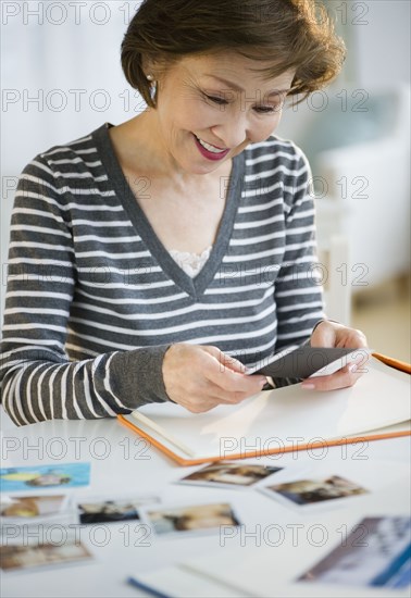 Japanese woman arranging photographs