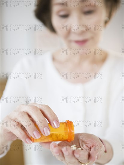 Japanese woman pouring medicine into hand