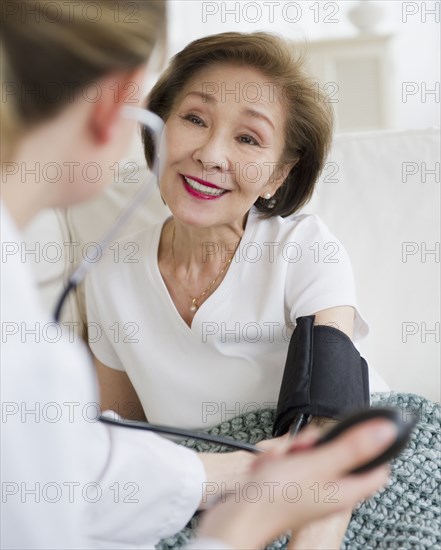 Doctor checking blood pressure of patient