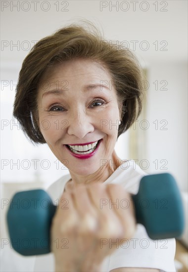 Japanese woman lifting hand weight