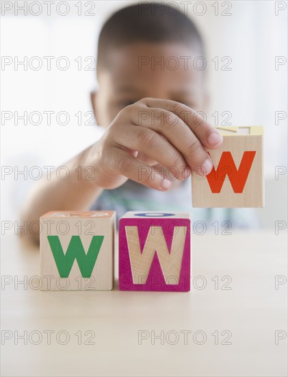 African American boy spelling WWW with blocks