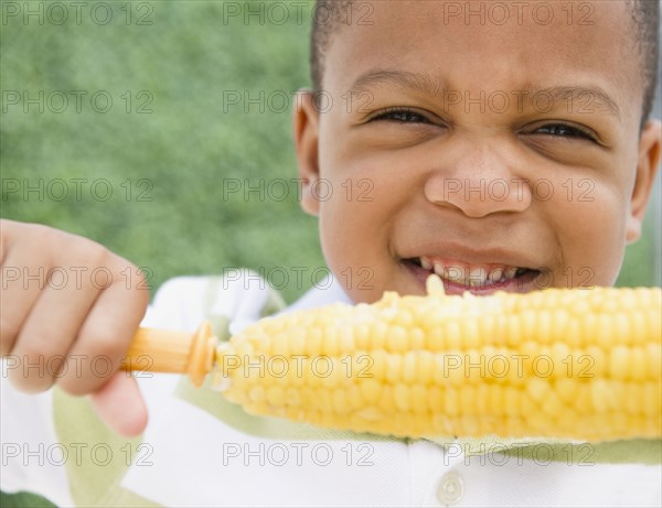 African American boy eating corn on the cob