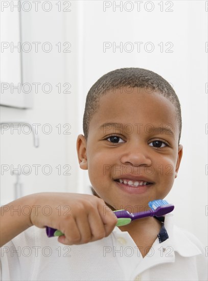 African American boy brushing teeth