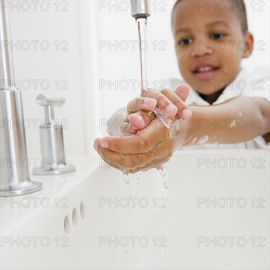 African American boy washing hands