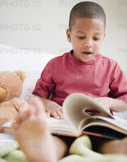 African American boy reading book