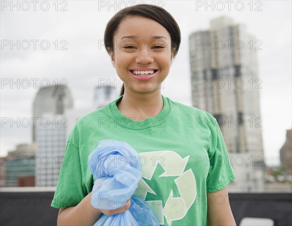 Smiling mixed race teenage girl wearing recycling t-shirt