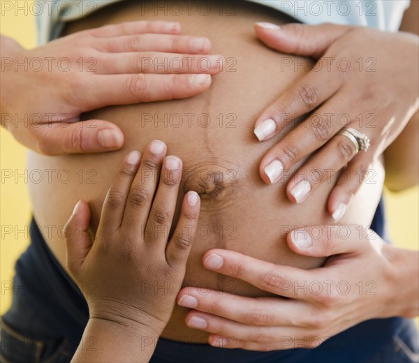 Close up of hands on pregnant woman's stomach