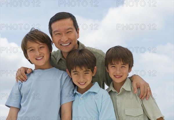 Smiling father and sons