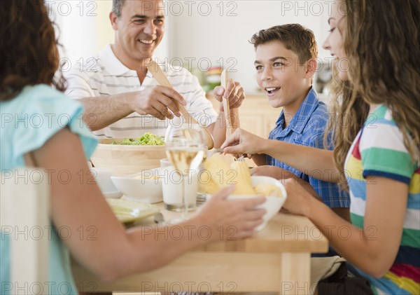 Happy family eating dinner together