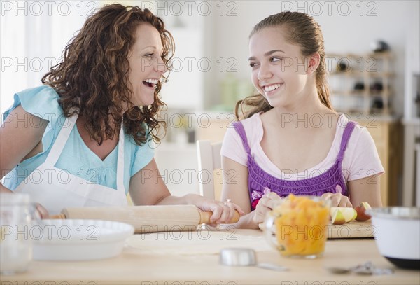 Hispanic mother and daughter baking together