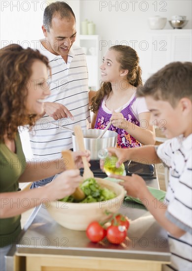 Hispanic family preparing dinner together