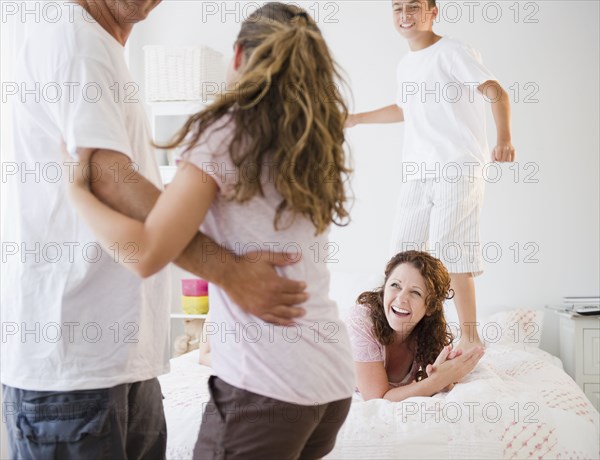 Laughing Hispanic family playing together