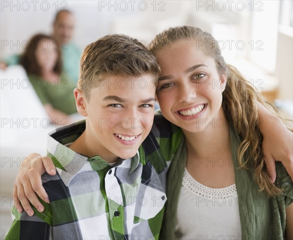 Hispanic brother and sister hugging