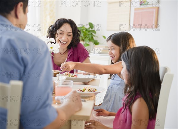 Laughing family having dinner together