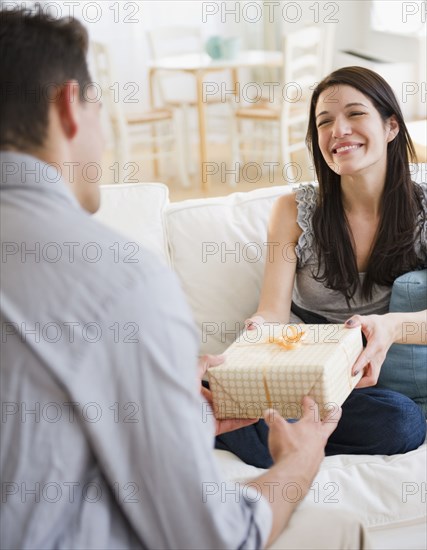 Husband giving gift to happy wife