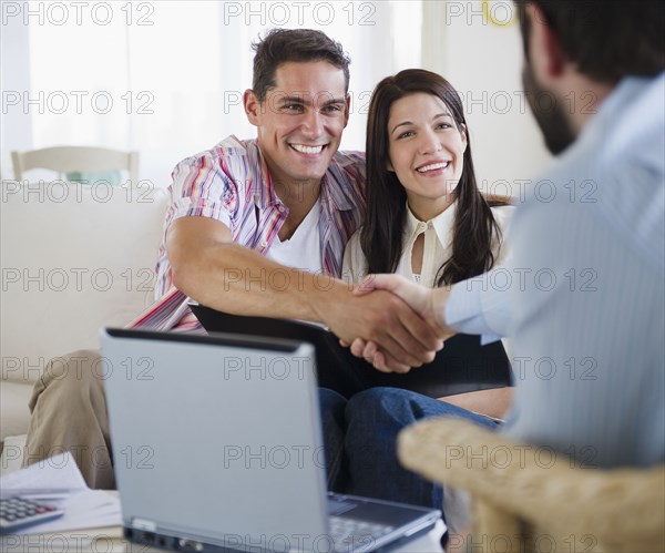 Couple greeting finance advisor