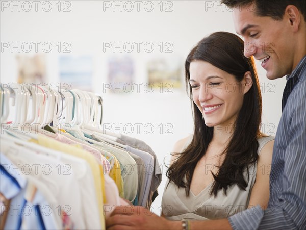 Smiling couple shopping for clothing together