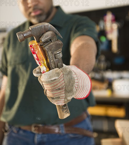 African American carpenter holding screwdriver