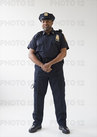 African American policeman with hands clasped