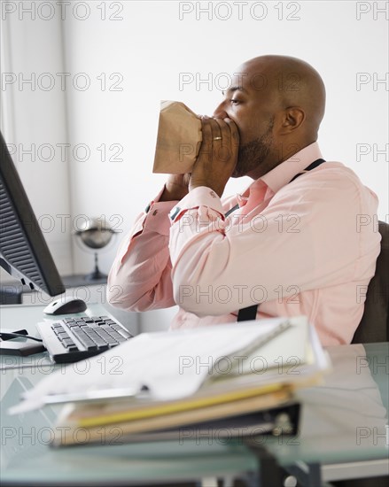 African American man breathing into paper bag