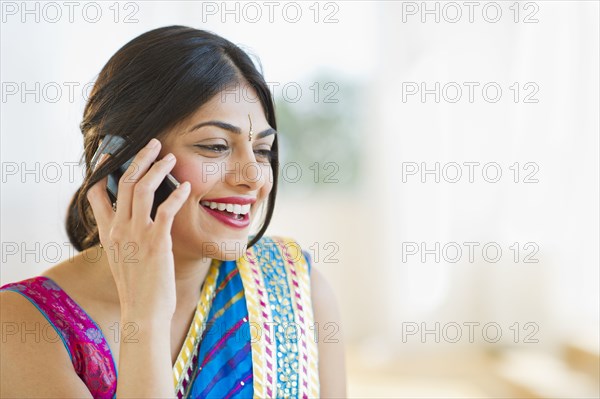 Indian woman in traditional Indian clothing talking on cell phone