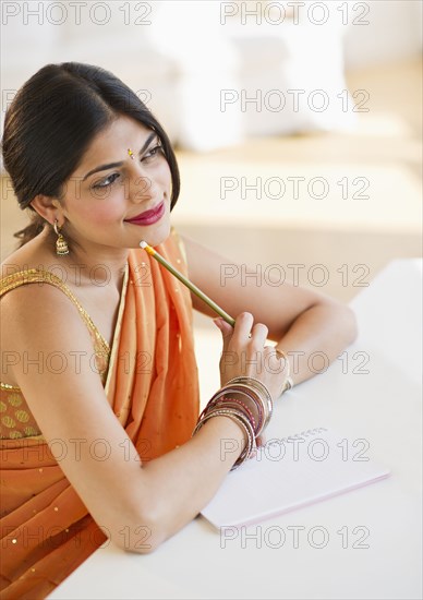 Indian woman in traditional Indian clothing thinking