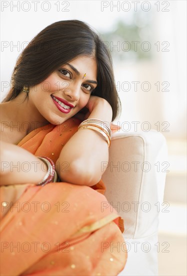 Indian woman in traditional Indian clothing sitting in chair