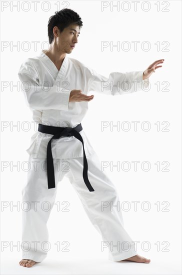 Asian male black belt practicing karate