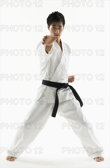 Asian male black belt practicing karate