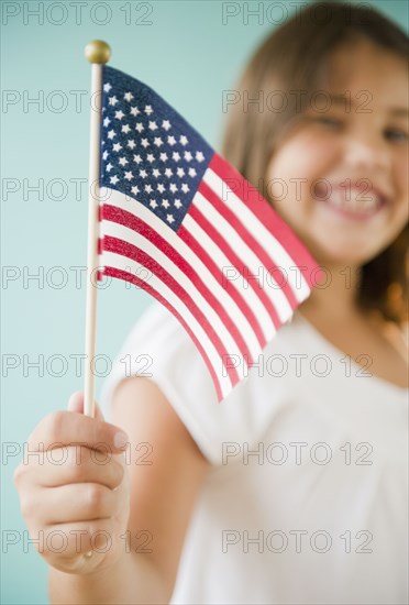 Hispanic girl holding American flag