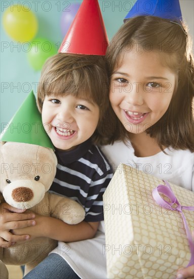 Hispanic brother and sister at birthday party