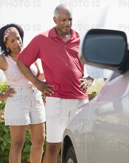 Black couple having car trouble on road trip